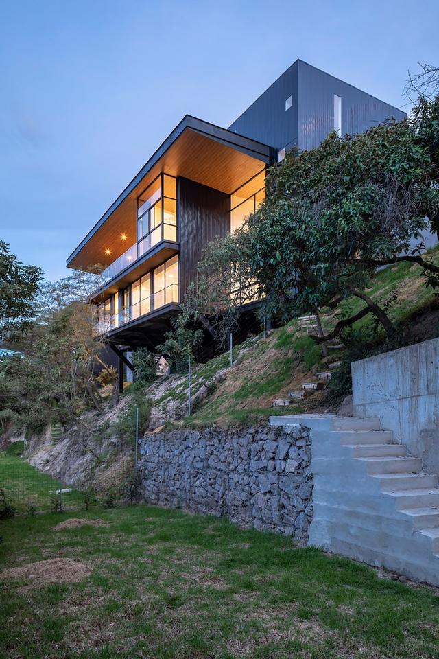 眺望山谷嵌在陡坡上的别墅