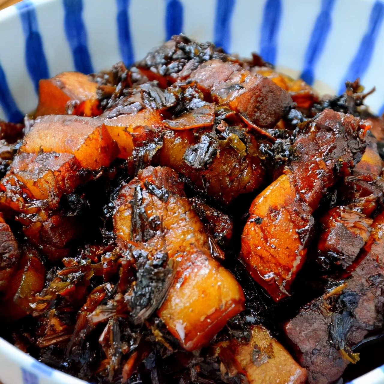 Authentic fried pork belly with dried plums and vegetables, one pot is