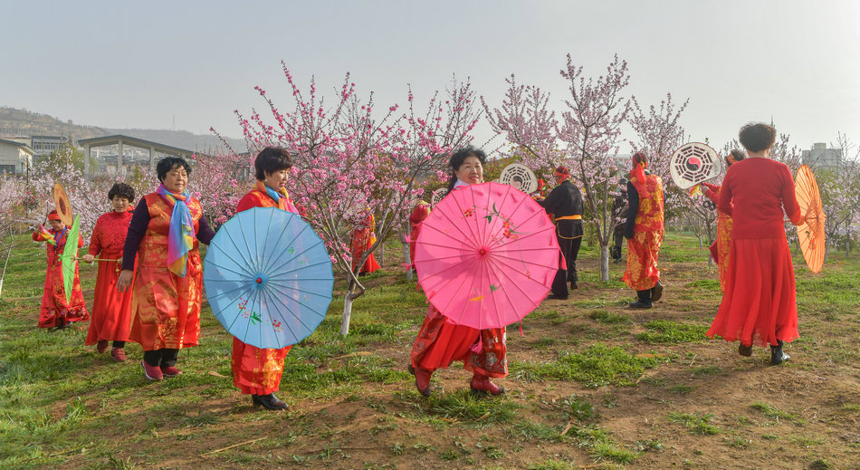 翠湖：桃花灼灼春色美，扇鼓咚咚夕阳红