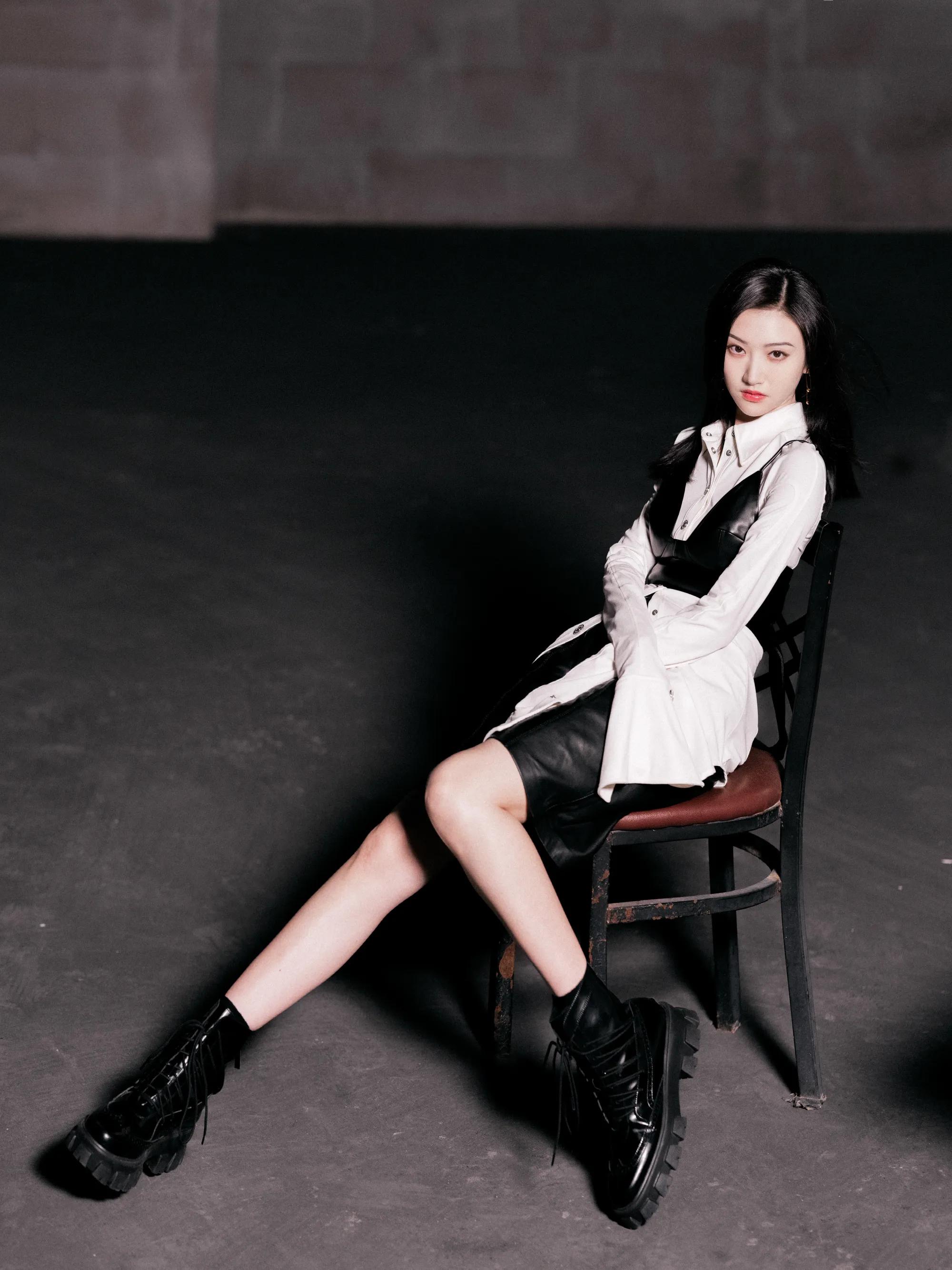 Jing Tian is wearing a white shirt and a black leather jacket with ...