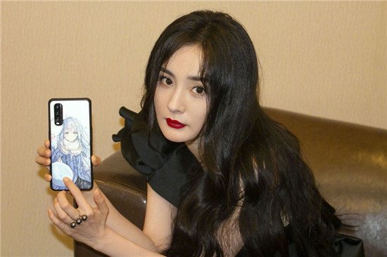 杨幂指着手机壳拍照，暗示自己还有颗少女心，