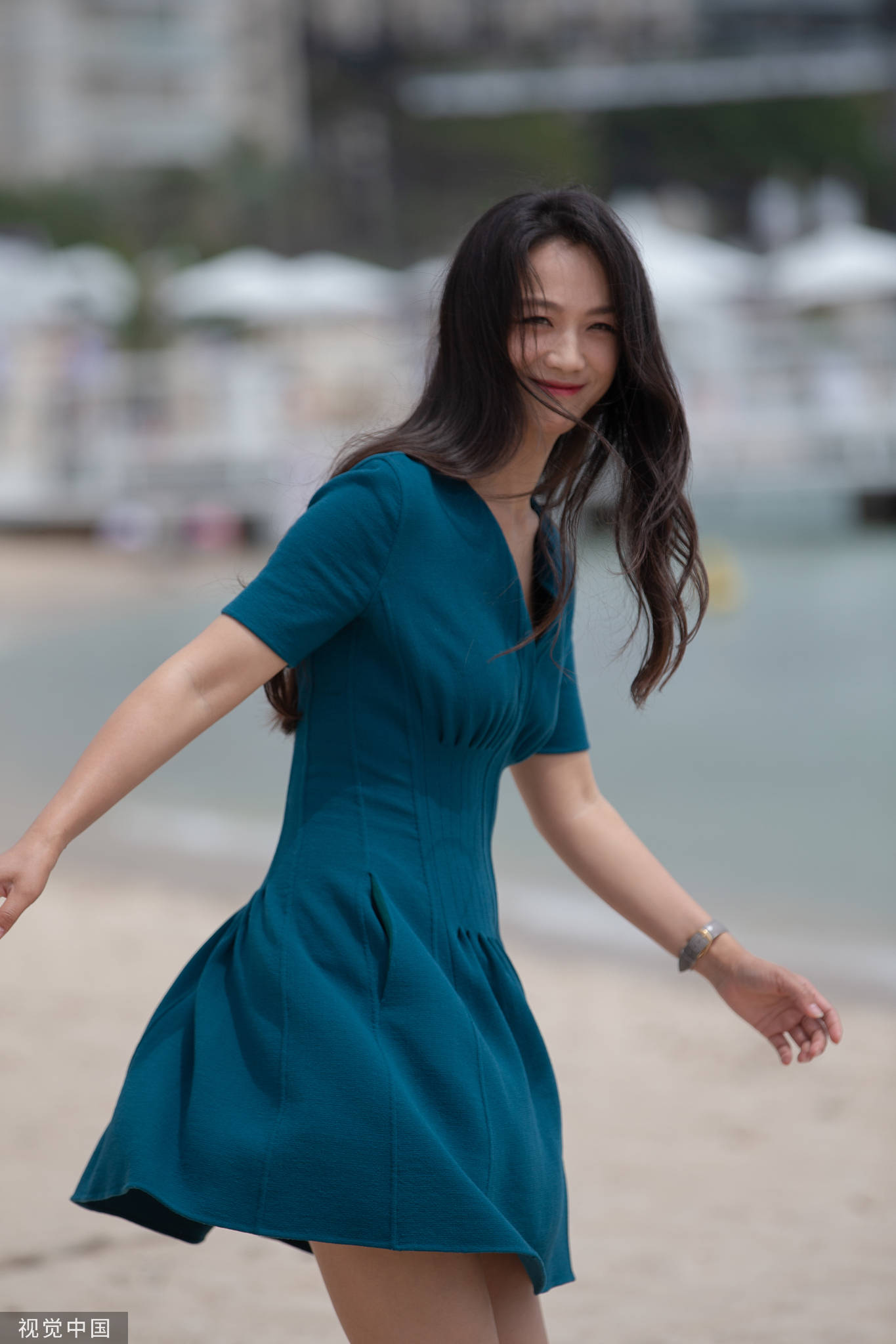 42-year-old Tang Wei takes a photo at the beach in Cannes - iMedia