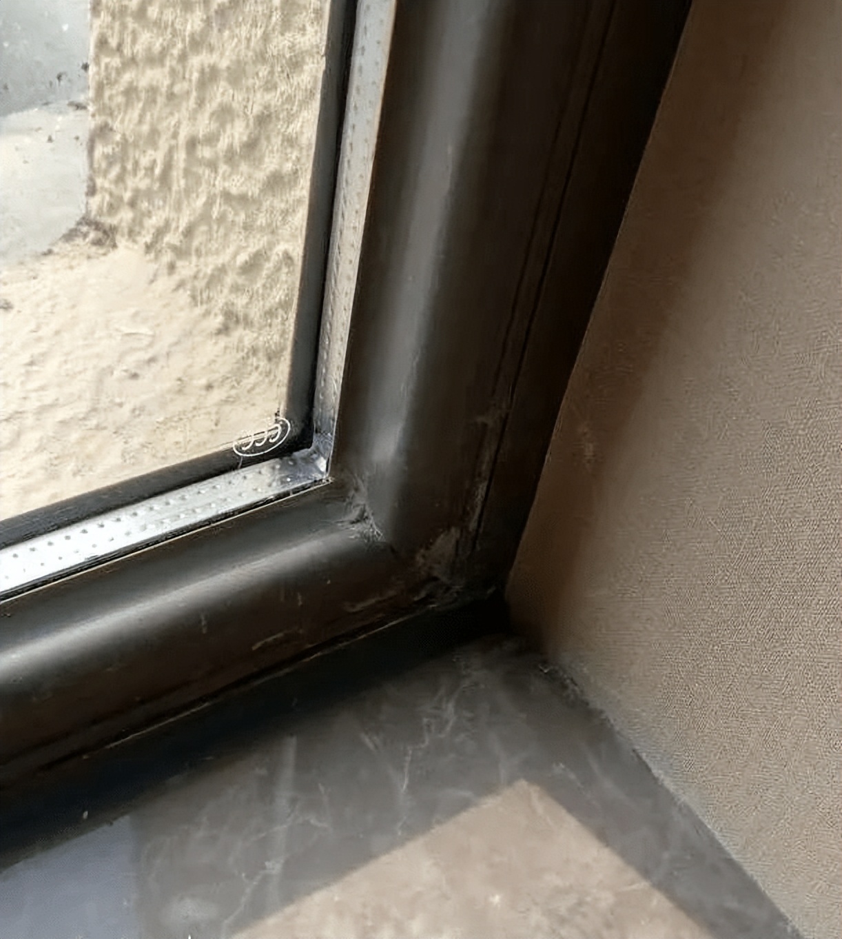 What is the cause of water seepage on the wall under the window sill
