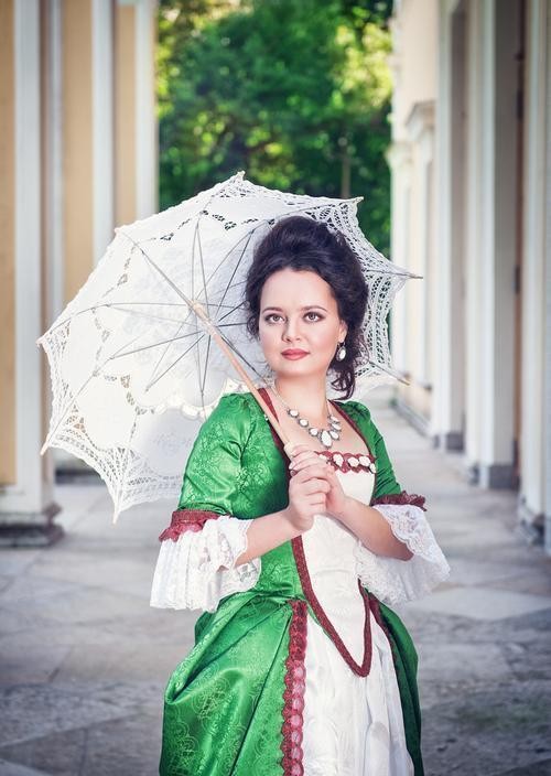 Explore the use and symbolic meaning of umbrellas in the European Middle Ages, and their impact