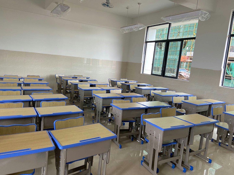 What is the appropriate distance between desks and chairs in the