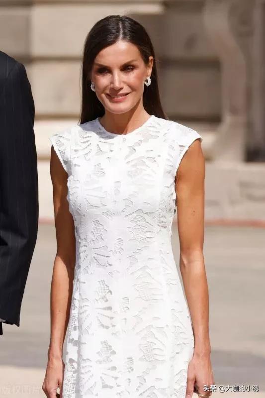Queen Letizia of Spain is wearing a white sleeveless dress + beige high