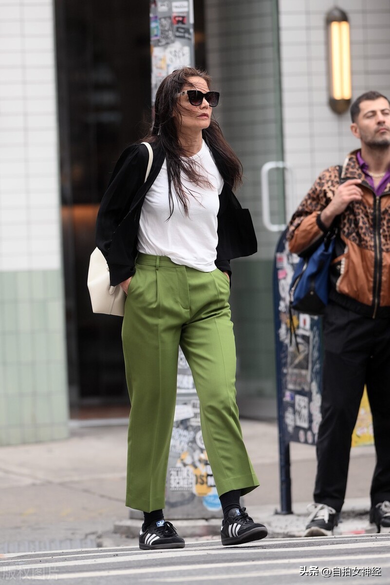 Katie Holmes is casual in a black cardigan + white Tshirt + green