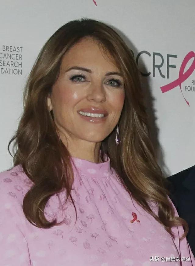 Elizabeth Hurley attends the event wearing a girly pink polka dot dress ...