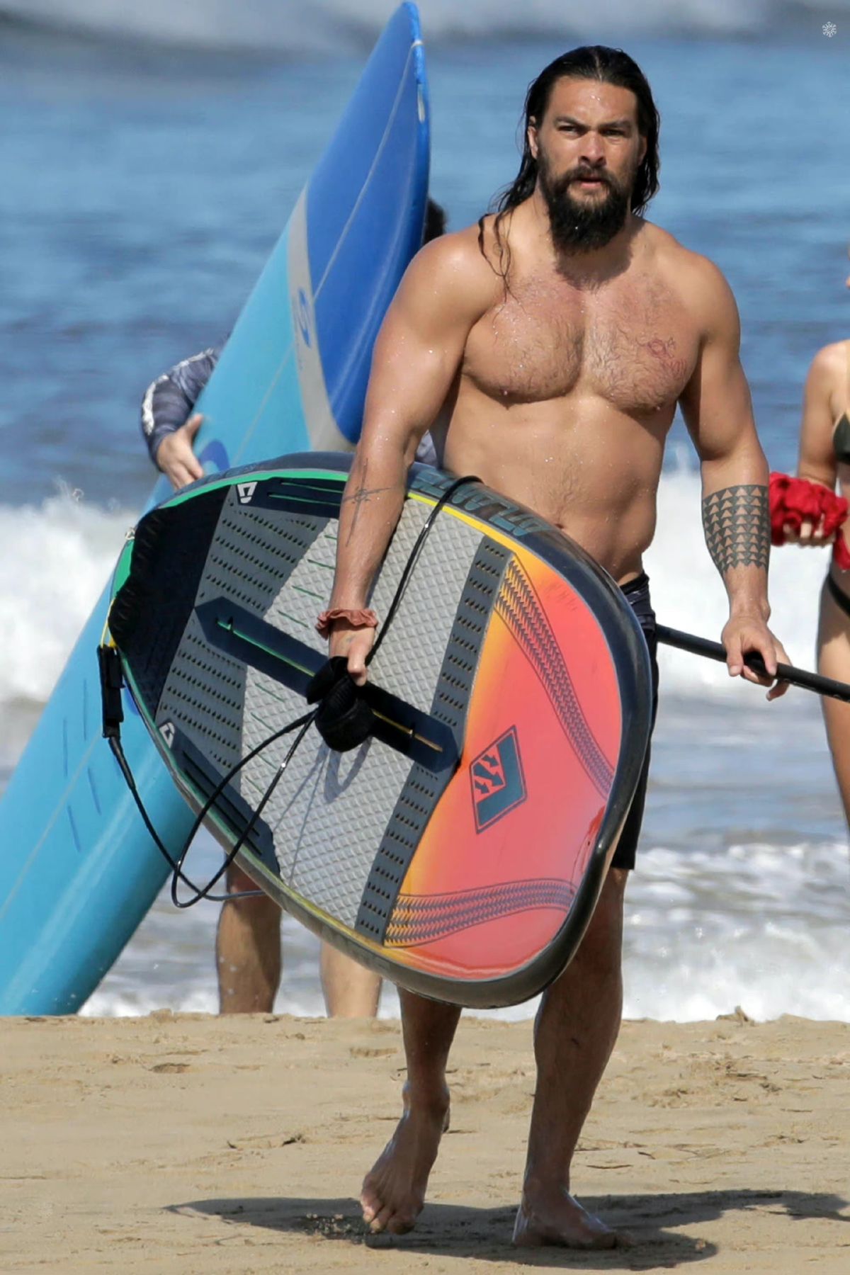 42-year-old Neptune surfs at sea, middle-aged with a blessing and belly ...