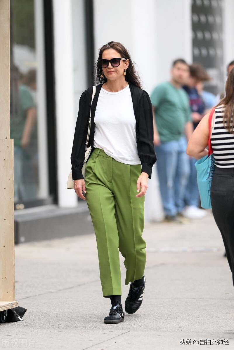 Katie Holmes is casual in a black cardigan + white Tshirt + green